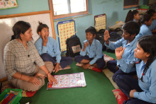 A female teacher in Nepal is teaching students with hearing impairment by using Sign language.